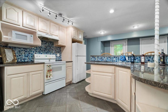 6363 Harmonridge Ct, Indianapolis, IN 46278 - kitchen featuring white appliances, under cabinet range hood, tasteful backsplash, and dark stone counters