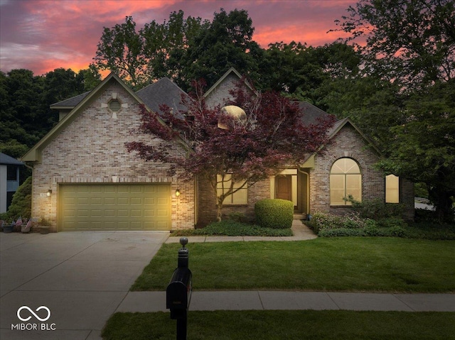 6363 Harmonridge Ct, Indianapolis, IN 46278 - view of front of home featuring driveway, an attached garage, a lawn, and brick siding