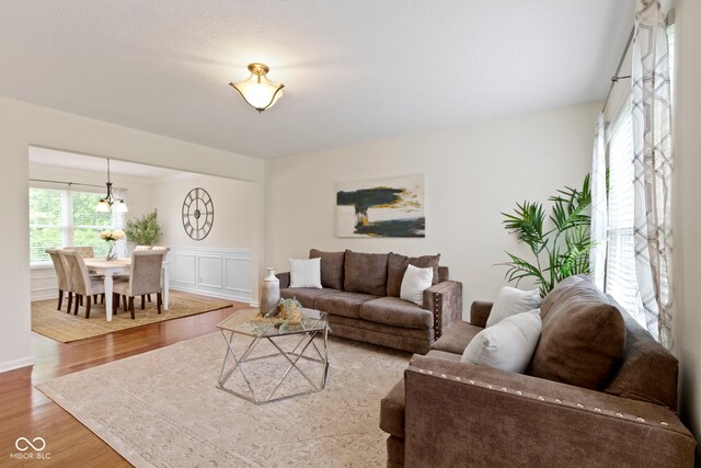 3014 Saddlehorn Dr, Carmel, IN 46033 - living area with a chandelier, wood finished floors, and wainscoting