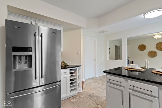 3014 Saddlehorn Dr, Carmel, IN 46033 - kitchen with stainless steel fridge with ice dispenser, white cabinets, and dark countertops