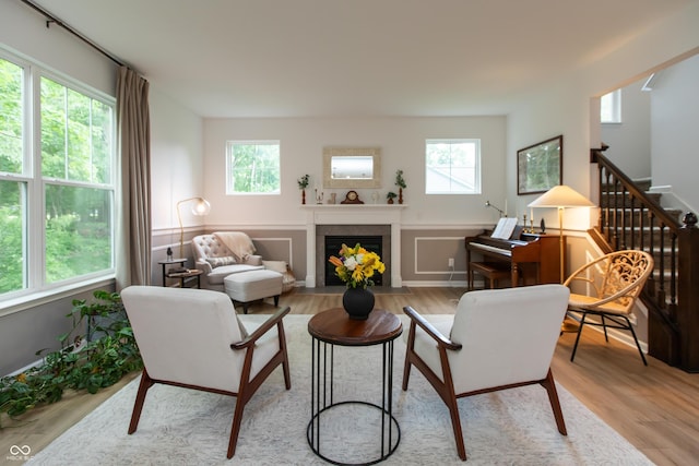 527 Macintosh Ln, Danville, IN 46122 - living area with healthy amount of natural light, light wood-type flooring, a fireplace with flush hearth, and stairway