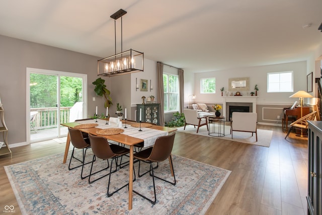 527 Macintosh Ln, Danville, IN 46122 - dining room with wood finished floors, a fireplace, and a chandelier