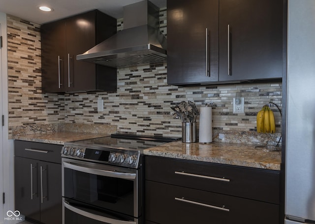 4000 N Meridian St Apt 11D, Indianapolis, IN 46208 - kitchen with stainless steel appliances, wall chimney range hood, tasteful backsplash, light stone counters, and recessed lighting