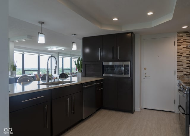4000 N Meridian St Apt 11D, Indianapolis, IN 46208 - kitchen with stainless steel appliances, a sink, dark cabinets, light countertops, and recessed lighting