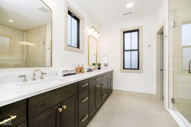 1818 Central Ave, Indianapolis, IN 46202 - bathroom featuring double vanity, a stall shower, baseboards, tile patterned floors, and recessed lighting