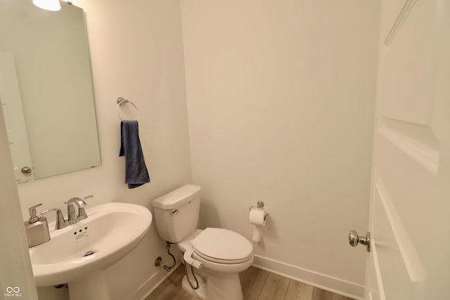 9640 Katana Cir, Fishers, IN 46040 - half bathroom with baseboards, a sink, toilet, and wood finished floors