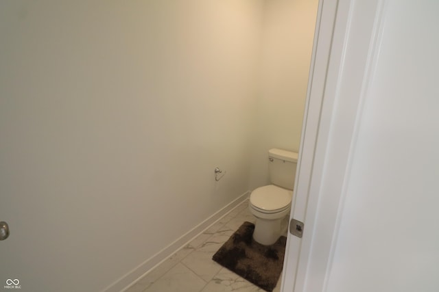 9640 Katana Cir, Fishers, IN 46040 - bathroom featuring marble look tile flooring, toilet, and baseboards