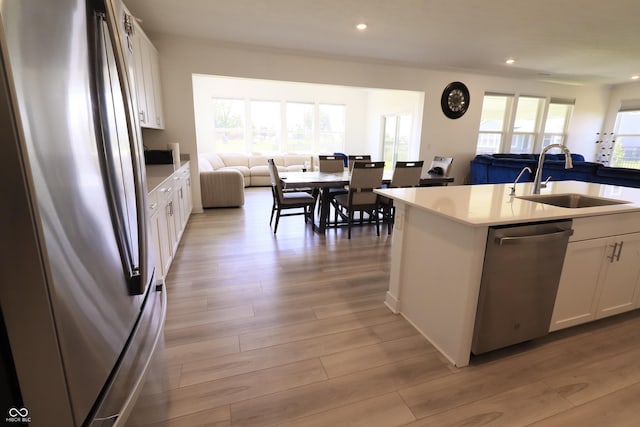 9640 Katana Cir, Fishers, IN 46040 - kitchen with stainless steel appliances, open floor plan, a sink, white cabinets, and recessed lighting