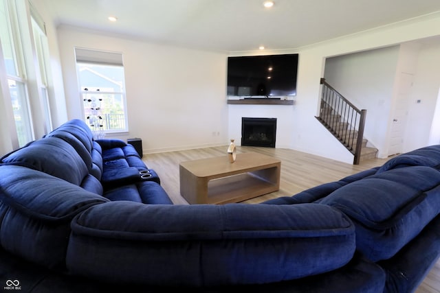 9640 Katana Cir, Fishers, IN 46040 - living area with wood finished floors, a fireplace, stairs, and recessed lighting
