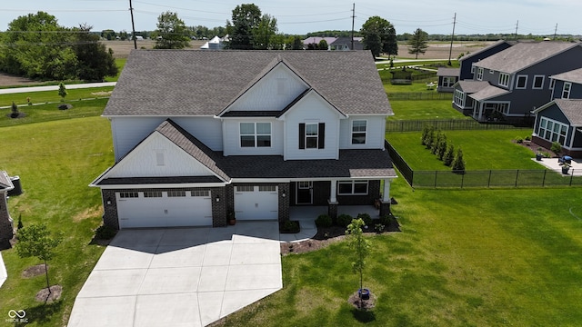 9640 Katana Cir, Fishers, IN 46040 - view of front of house with roof with shingles, driveway, a garage, covered porch, and brick siding