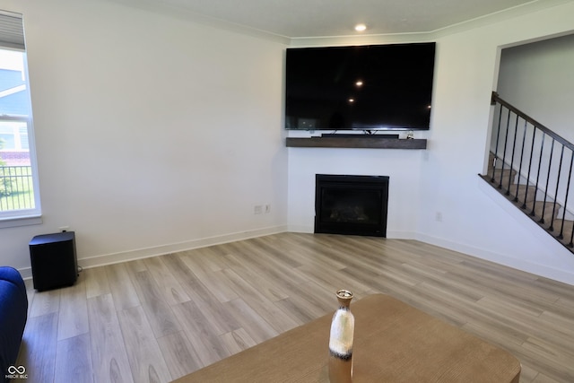 9640 Katana Cir, Fishers, IN 46040 - unfurnished living room featuring light wood-style flooring, a fireplace, stairs, baseboards, and recessed lighting