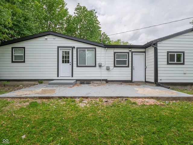 1141 Temperance Ave, Indianapolis, IN 46203 - rear view of property featuring a lawn and a patio area