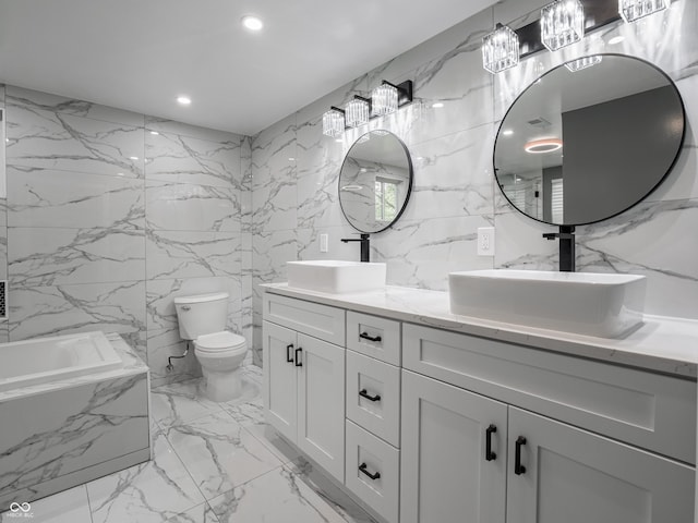 1141 Temperance Ave, Indianapolis, IN 46203 - full bath with tile walls, double vanity, a tub with marble appearance, marble tiled floors, and toilet