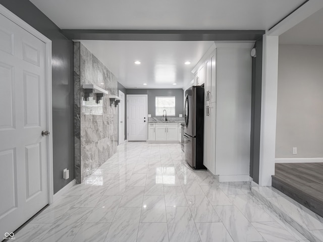 1141 Temperance Ave, Indianapolis, IN 46203 - hallway with a sink, recessed lighting, light marble finish floors, and baseboards