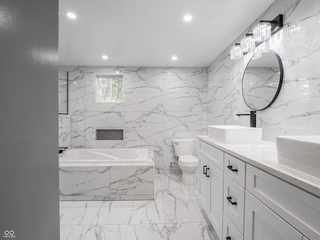 1141 Temperance Ave, Indianapolis, IN 46203 - bathroom with marble tiled flooring, a garden tub, double vanity, recessed lighting, and toilet