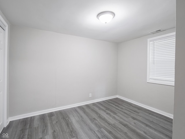 1141 Temperance Ave, Indianapolis, IN 46203 - empty room featuring dark wood-style flooring and baseboards