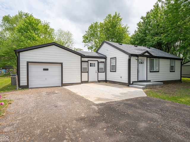 1141 Temperance Ave, Indianapolis, IN 46203 - ranch-style house with driveway and an attached garage