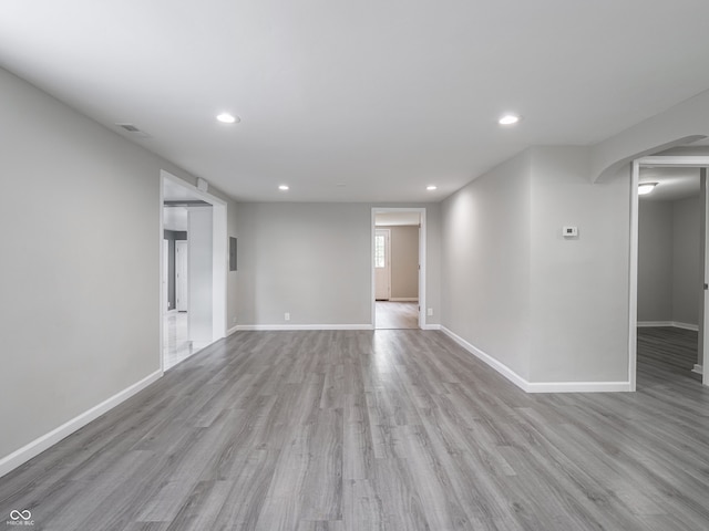 1141 Temperance Ave, Indianapolis, IN 46203 - spare room with wood finished floors, recessed lighting, baseboards, and arched walkways