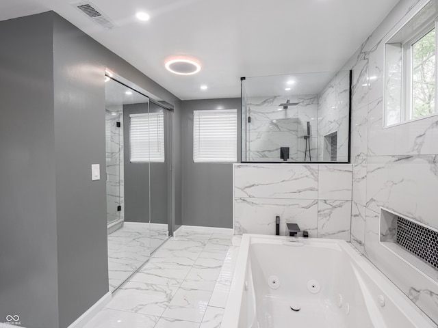 1141 Temperance Ave, Indianapolis, IN 46203 - bathroom featuring marble look tile flooring, a marble finish shower, a jetted tub, and recessed lighting