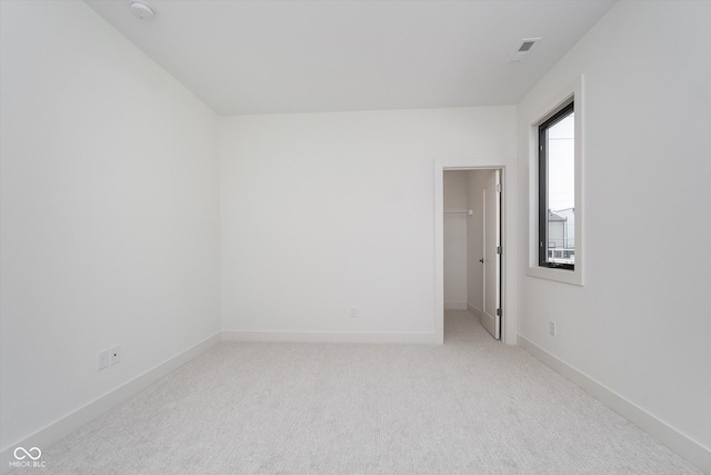 1822 Central Ave, Indianapolis, IN 46202 - spare room featuring light carpet, baseboards, and a smoke detector