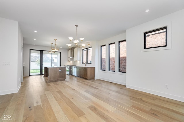1822 Central Ave, Indianapolis, IN 46202 - kitchen featuring light countertops, a chandelier, a center island, light wood finished floors, and baseboards
