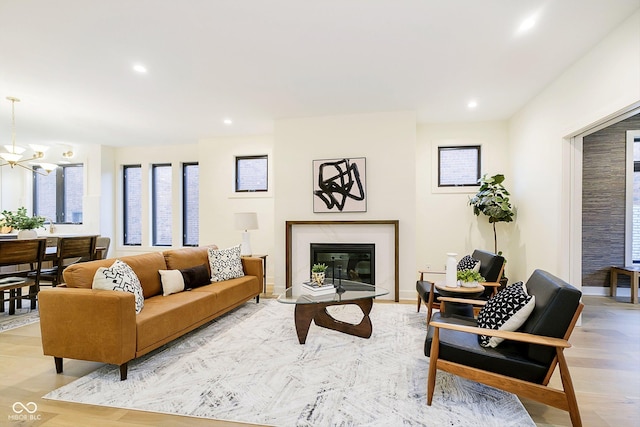 1822 Central Ave, Indianapolis, IN 46202 - living area featuring a glass covered fireplace, a chandelier, recessed lighting, and light wood-style floors