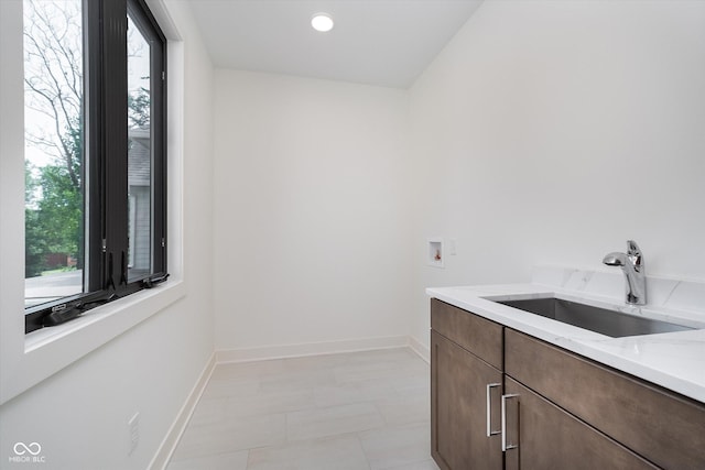 1822 Central Ave, Indianapolis, IN 46202 - washroom featuring washer hookup, baseboards, and cabinet space