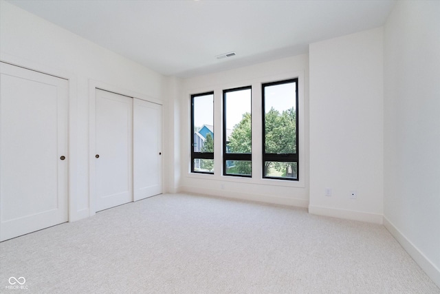 1822 Central Ave, Indianapolis, IN 46202 - unfurnished bedroom featuring carpet flooring, baseboards, and multiple closets