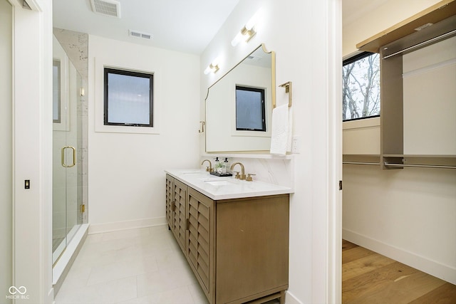 1822 Central Ave, Indianapolis, IN 46202 - full bathroom with double vanity, baseboards, and a stall shower