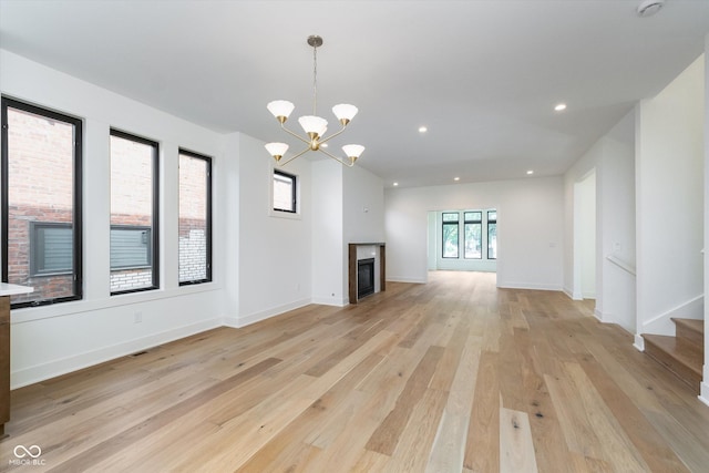 1822 Central Ave, Indianapolis, IN 46202 - unfurnished living room featuring light wood finished floors, a fireplace, a chandelier, baseboards, and recessed lighting