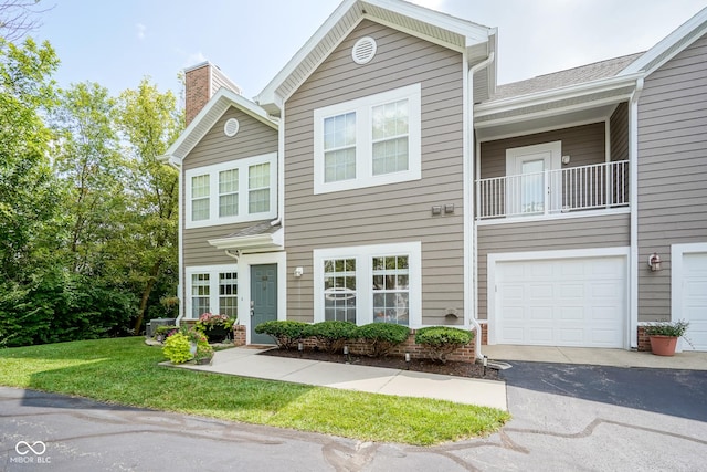 9743 Herons Cv, Carmel, IN 46280 - townhome / multi-family property with driveway, a chimney, and a garage