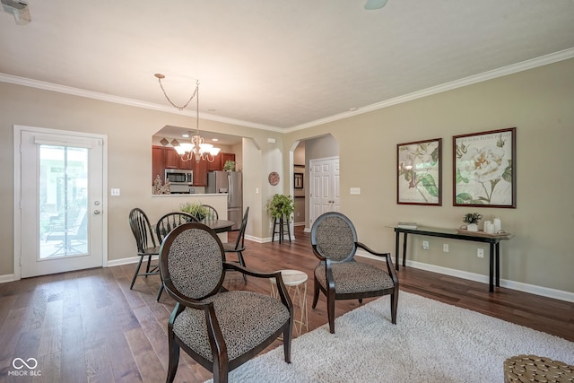 9743 Herons Cv, Carmel, IN 46280 - dining space with arched walkways, dark wood-style floors, ornamental molding, a chandelier, and baseboards