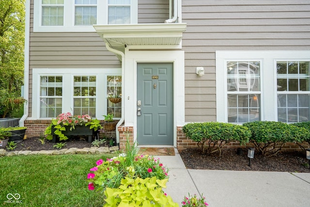 9743 Herons Cv, Carmel, IN 46280 - doorway to property with central AC unit and brick siding