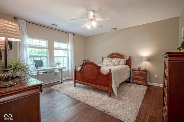 9743 Herons Cv, Carmel, IN 46280 - bedroom with baseboards, dark wood-type flooring, a ceiling fan, and a desk