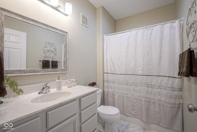 9743 Herons Cv, Carmel, IN 46280 - full bathroom with vanity, toilet, and marble finish flooring