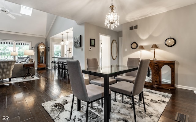 2949 River Bay Dr N, Indianapolis, IN 46240 - dining area with a chandelier, dark wood-style floors, baseboards, vaulted ceiling, and a skylight