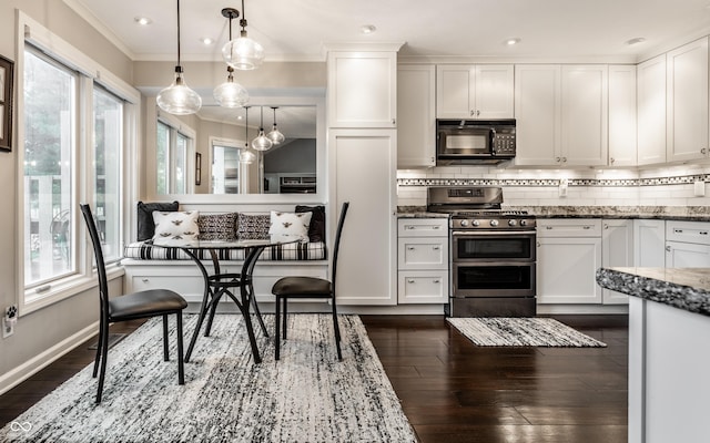 2949 River Bay Dr N, Indianapolis, IN 46240 - kitchen with stainless steel gas stove, black microwave, plenty of natural light, white cabinets, and crown molding