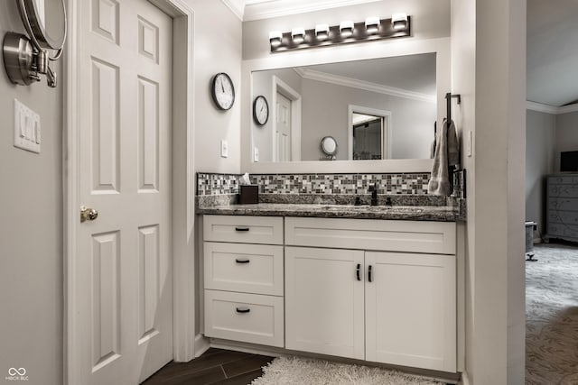 2949 River Bay Dr N, Indianapolis, IN 46240 - bathroom with ornamental molding, vanity, decorative backsplash, and wood finished floors