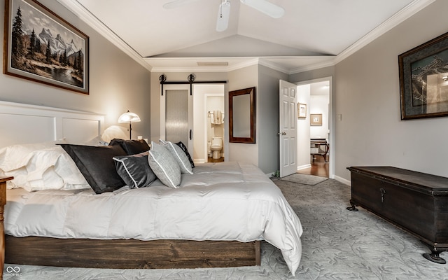 2949 River Bay Dr N, Indianapolis, IN 46240 - carpeted bedroom with vaulted ceiling, a barn door, ensuite bath, crown molding, and baseboards