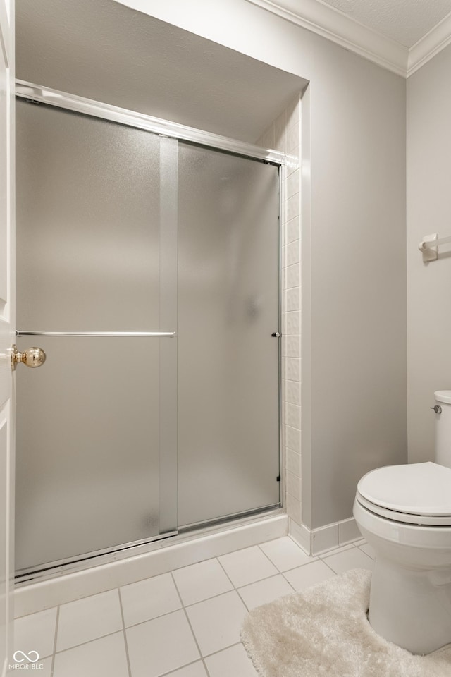 2949 River Bay Dr N, Indianapolis, IN 46240 - full bathroom with ornamental molding, toilet, tile patterned floors, and a shower stall