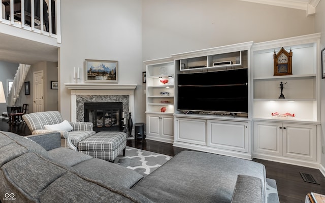2949 River Bay Dr N, Indianapolis, IN 46240 - living room featuring dark wood-type flooring, a fireplace, a high ceiling, and crown molding