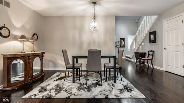 2949 River Bay Dr N, Indianapolis, IN 46240 - dining area featuring dark wood-type flooring, a chandelier, stairway, and baseboards