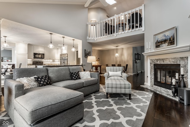 2949 River Bay Dr N, Indianapolis, IN 46240 - living area with dark wood-style floors, high vaulted ceiling, ceiling fan, a fireplace, and baseboards