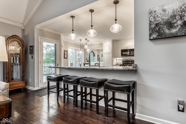 2949 River Bay Dr N, Indianapolis, IN 46240 - kitchen featuring stove, ornamental molding, a breakfast bar area, light stone counters, and black microwave