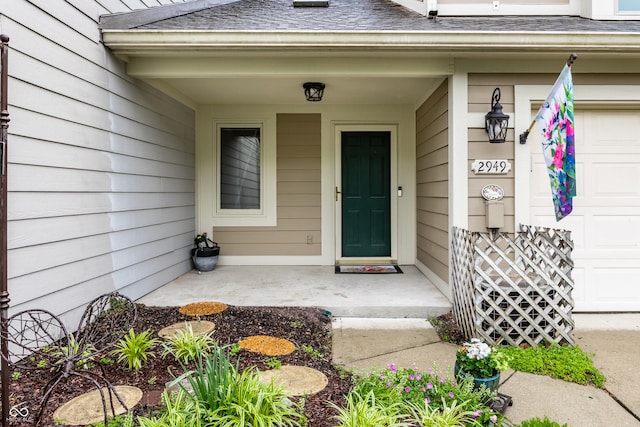 2949 River Bay Dr N, Indianapolis, IN 46240 - property entrance with a garage, a shingled roof, and covered porch