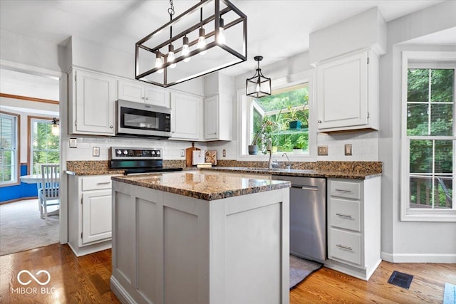 11956 Glen Cove Dr, Indianapolis, IN 46236 - kitchen with stainless steel appliances, backsplash, wood finished floors, and healthy amount of natural light