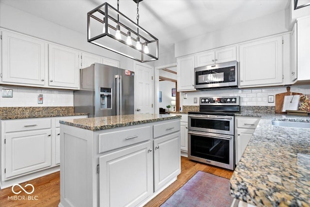 11956 Glen Cove Dr, Indianapolis, IN 46236 - kitchen featuring stainless steel appliances, a center island, and white cabinetry