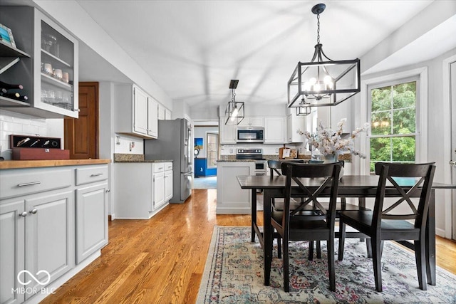 11956 Glen Cove Dr, Indianapolis, IN 46236 - dining space with a chandelier and light wood-type flooring