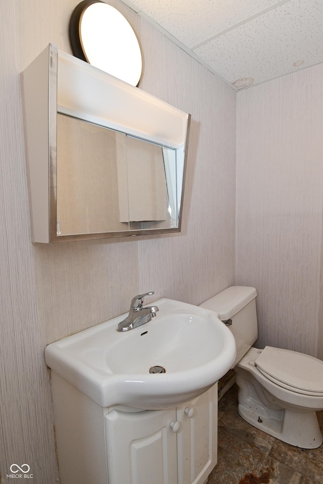 3668 Chatsbee Ct, Indianapolis, IN 46224 - bathroom with vanity, toilet, and wallpapered walls
