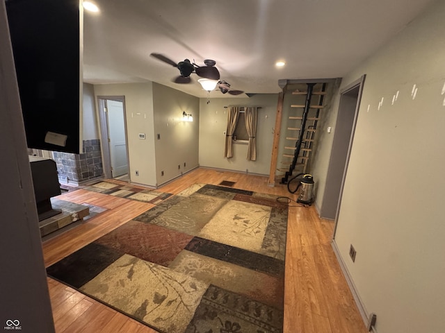 16952 Bookout Rd, Hagerstown, IN 47346 - living room featuring wood finished floors, a ceiling fan, baseboards, a wood stove, and recessed lighting